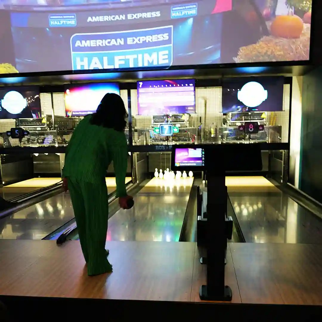 Woman trying duckpin bowling for her first time at Winner's Circle
